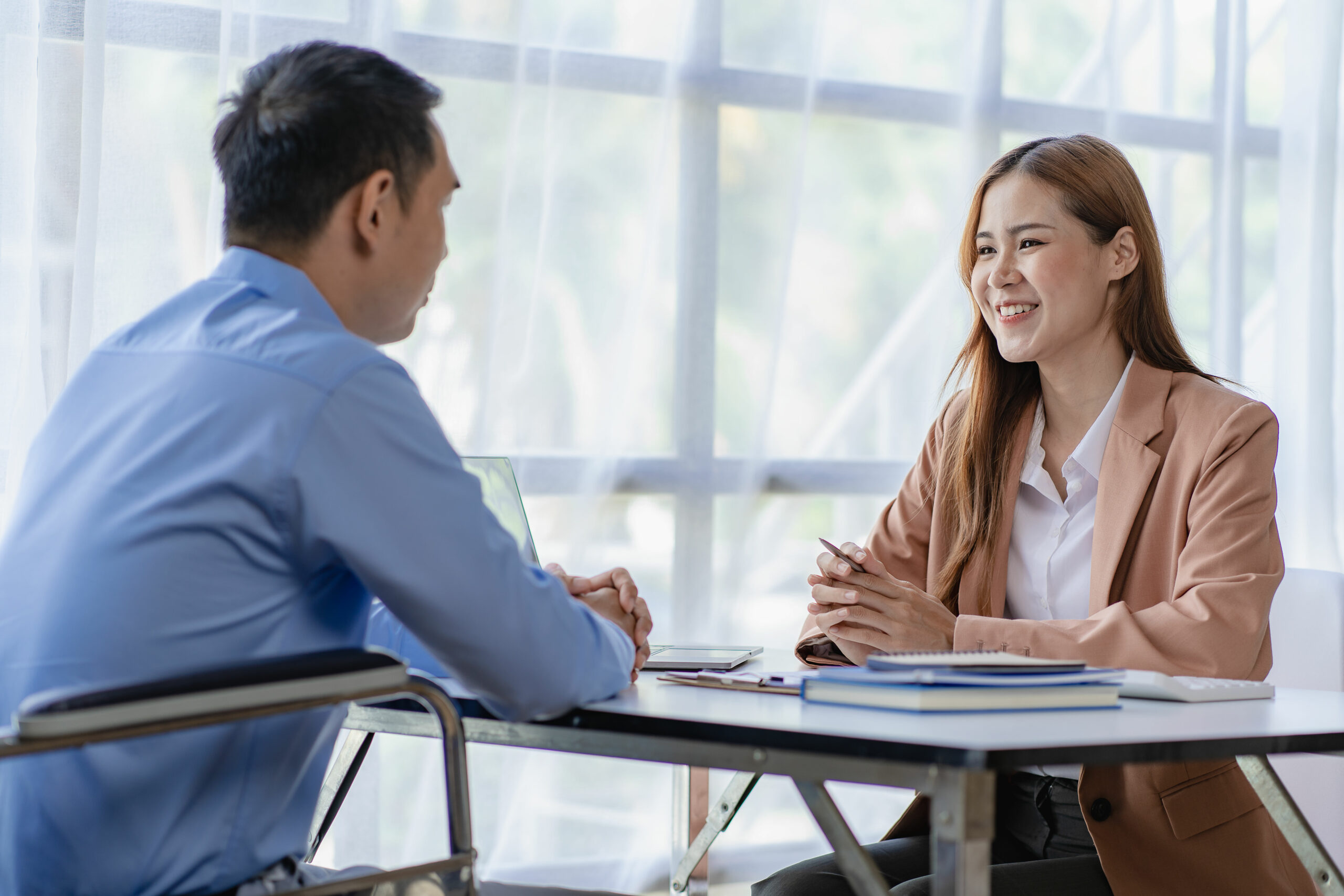 Asian male businessman and female accountant meeting financial budget, financial graph analysis with laptop, calculate with calculator in office.